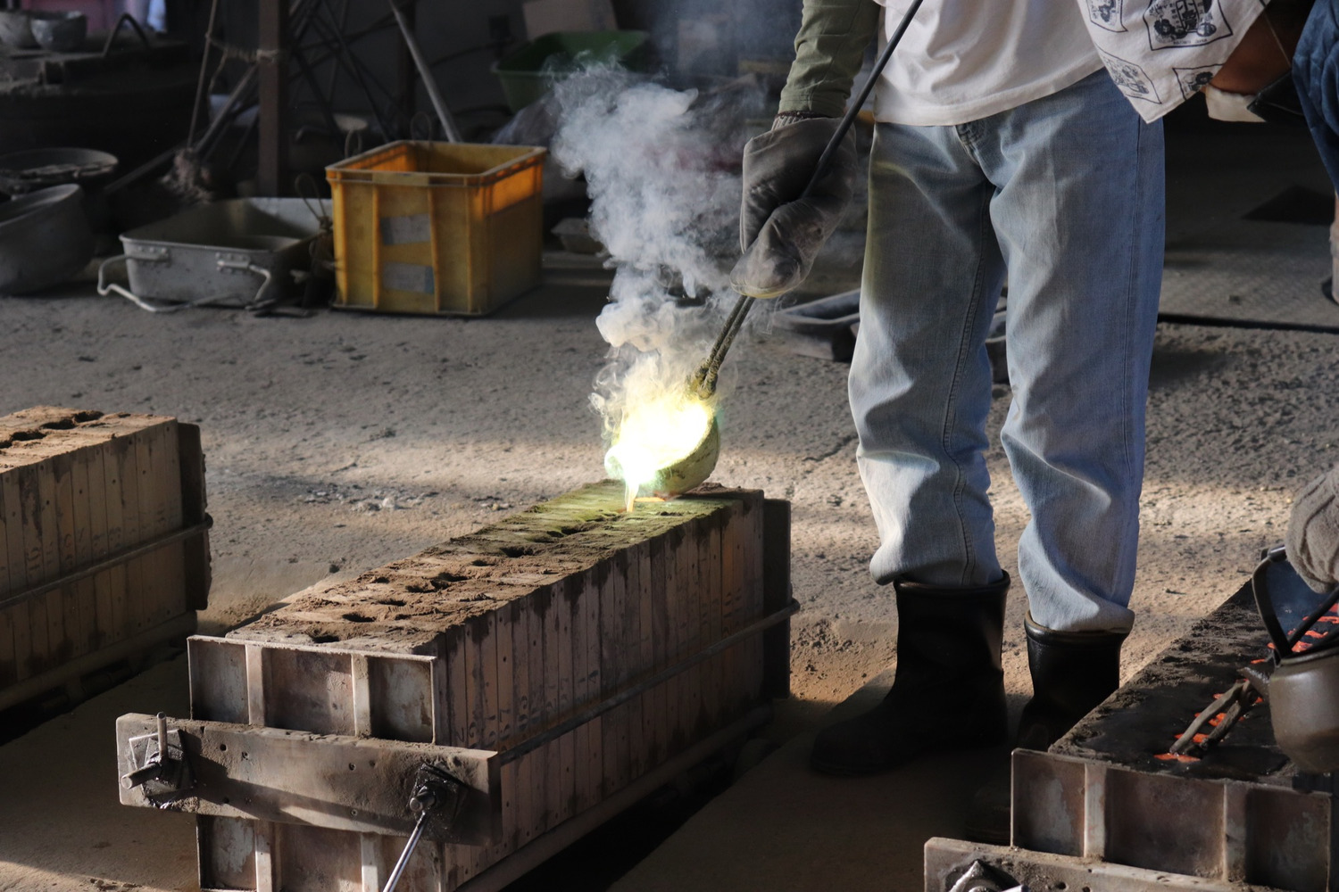 砂型に真鍮を流し込む職人の手仕事